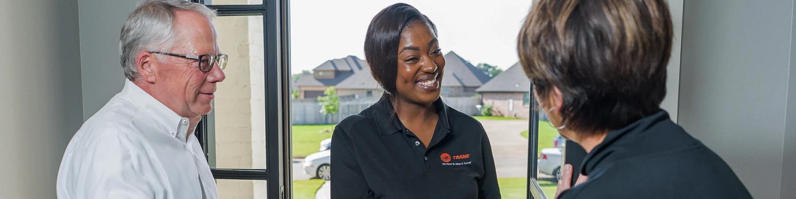 A family greets their HVAC technician.