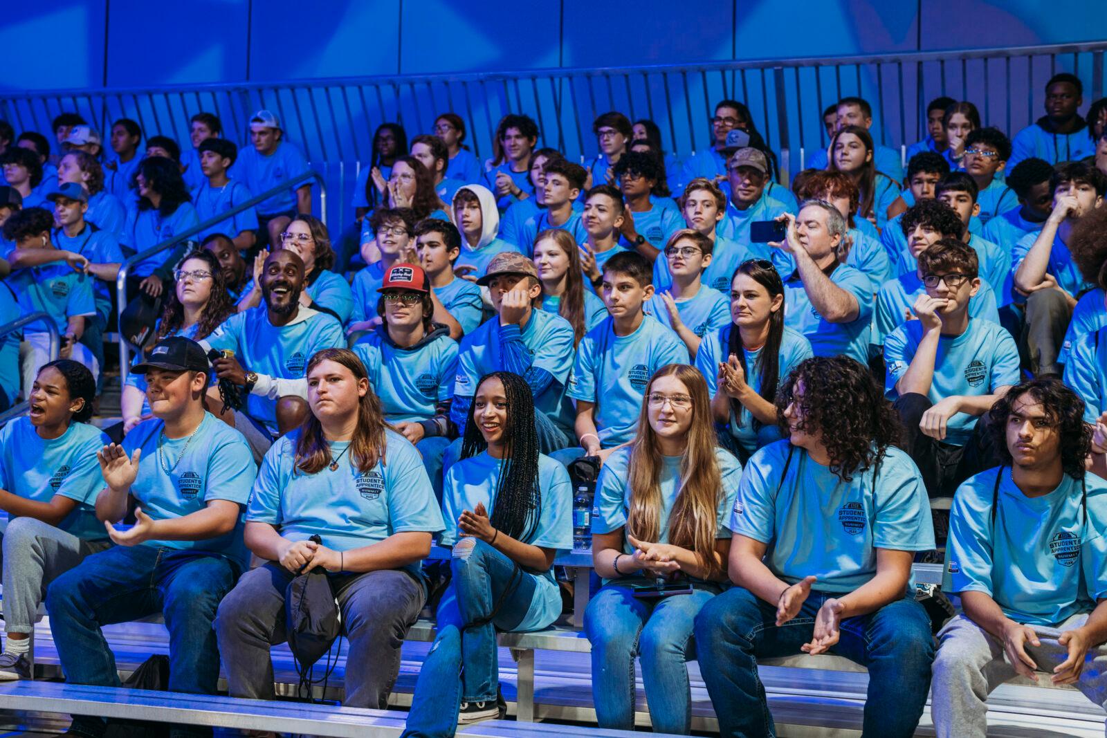 There is an audience watching a competition.