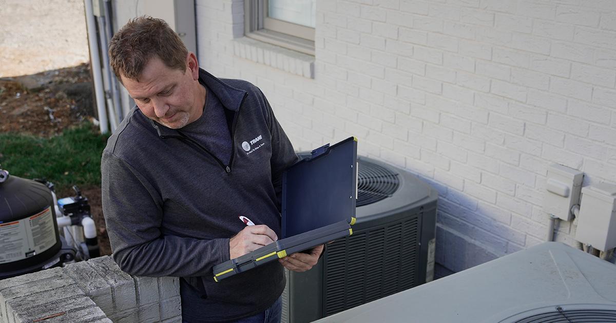 HVAC Technician with HVAC Maintenance Checklist